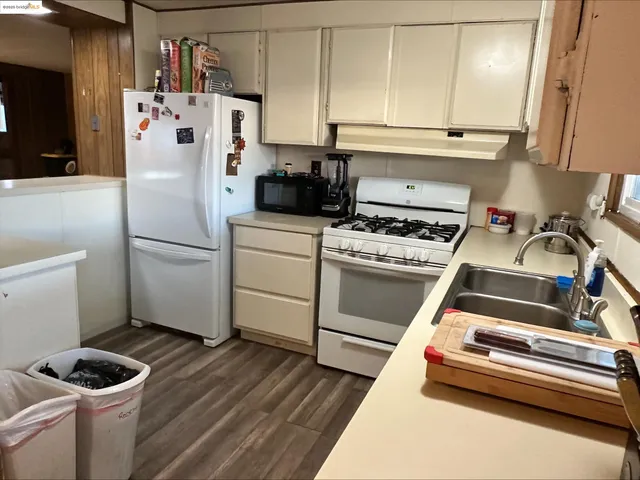 a white refrigerator freezer sitting inside of a kitchen