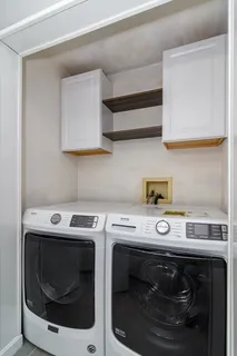 a utility room with dryer washer and sink