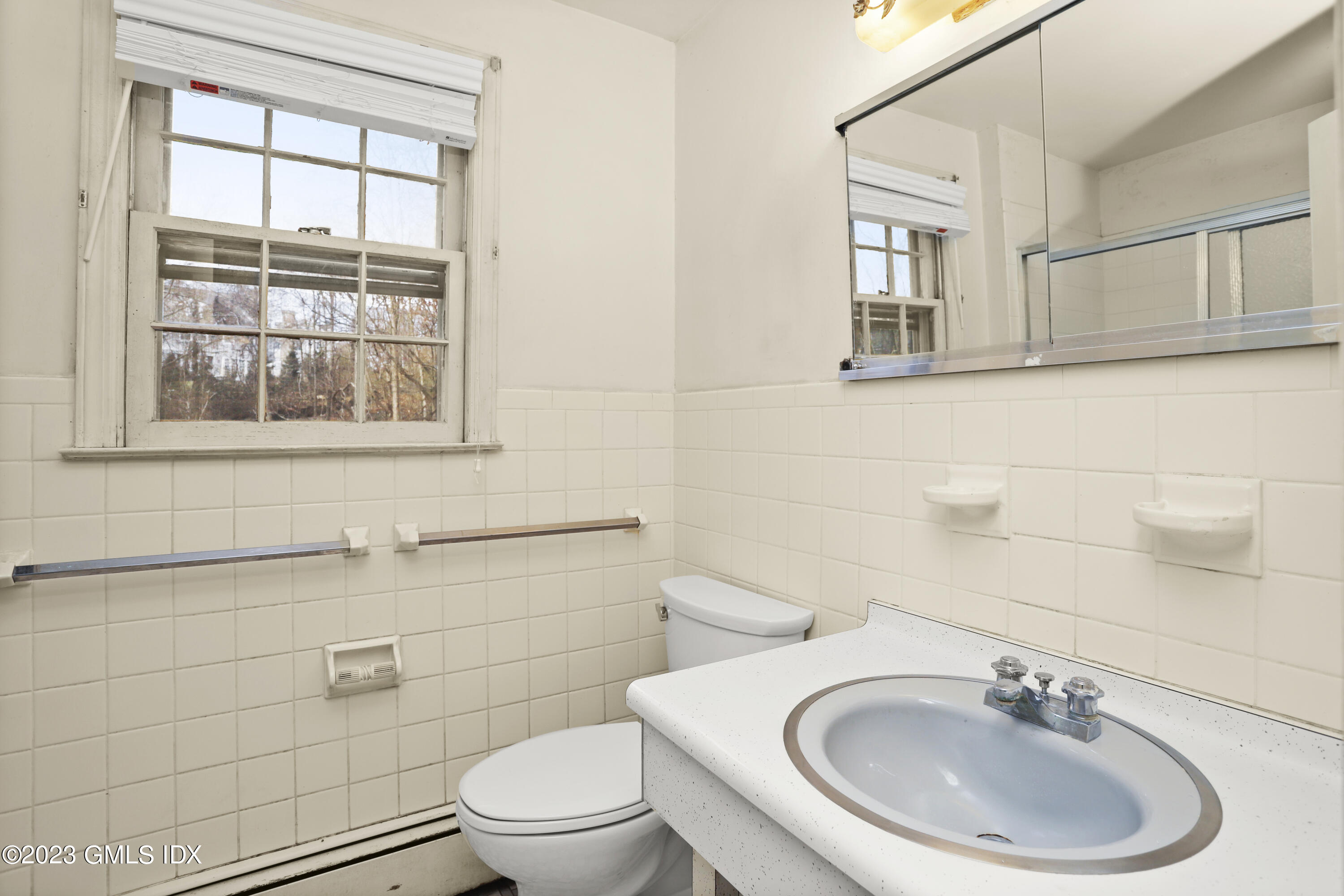 46 Dandy Drive Cos Cob, CT 06807 - Photo 15 of 26 a bathroom with a sink a toilet and a mirror