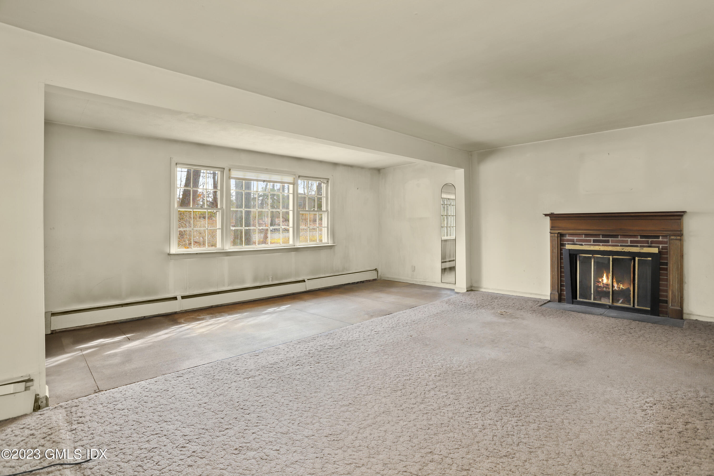 46 Dandy Drive Cos Cob, CT 06807 - Photo 19 of 26 an empty room with windows and fireplace