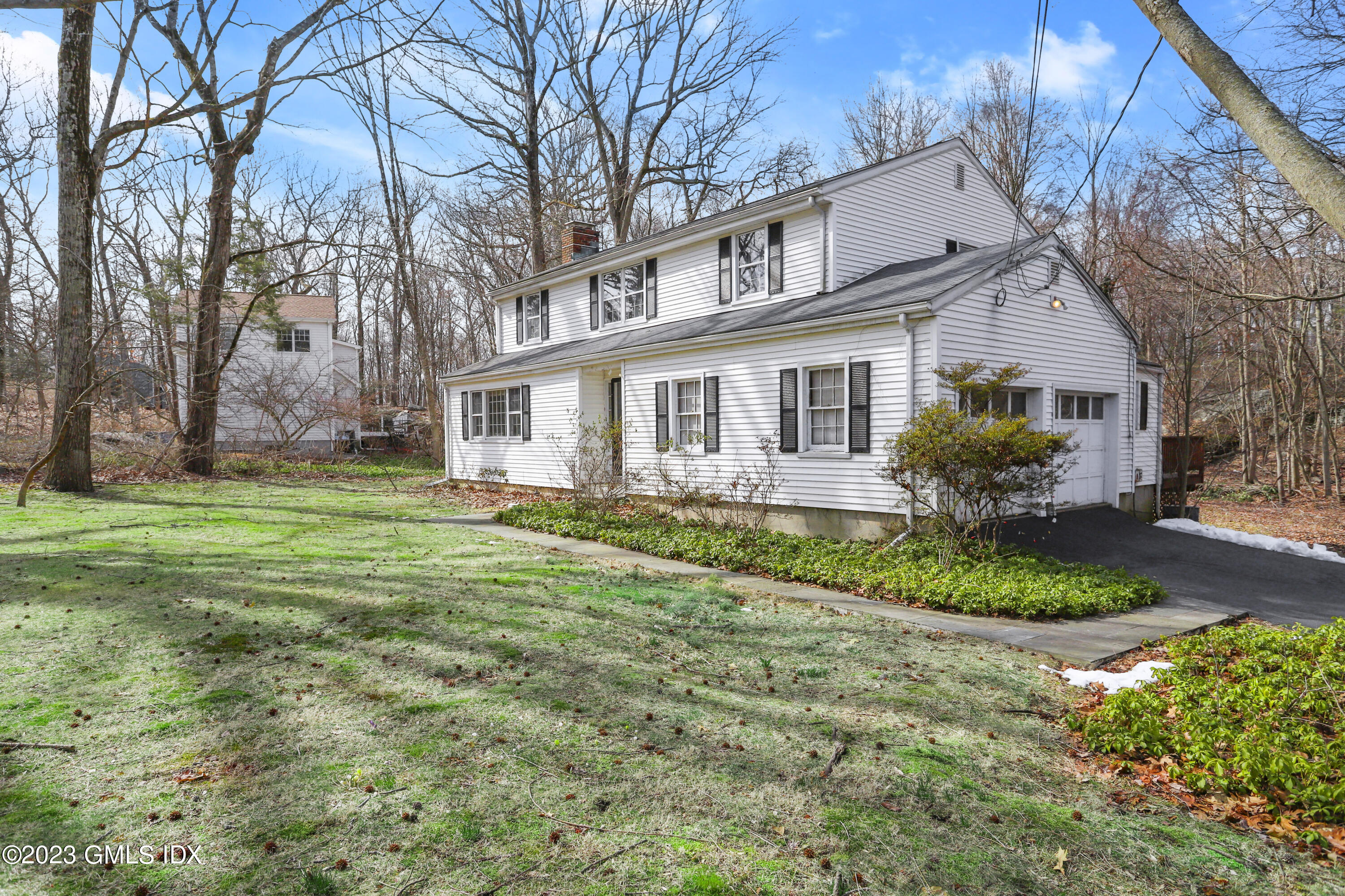 46 Dandy Drive Cos Cob, CT 06807 - Photo 3 of 26 a front view of a house with a garden