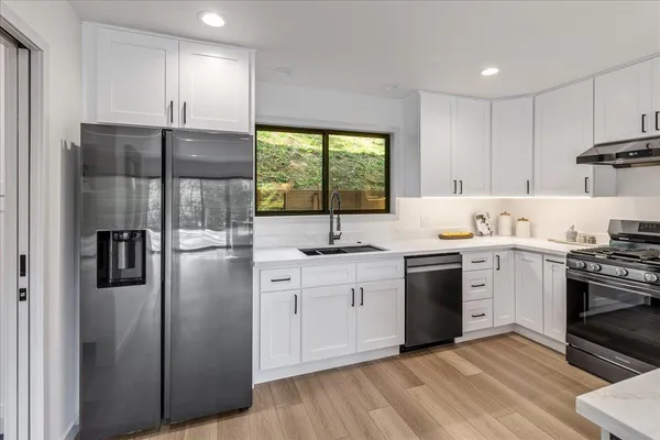 a kitchen with a sink and large window