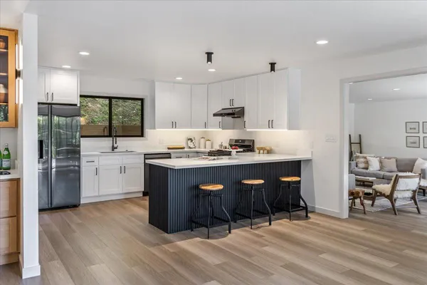 a view of a bedroom with furniture and window