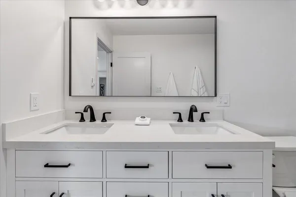 a bed room with a bed and a night stand