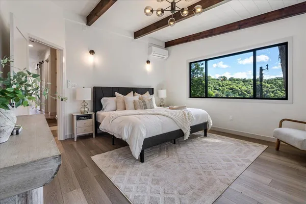 a bed sitting in a bedroom next to a window