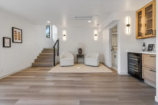 a view of a hallway with wooden floor and staircase