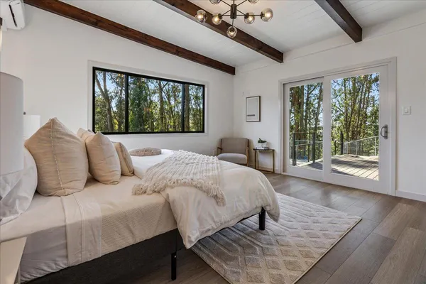 a bathroom with a granite countertop sink a toilet a mirror and shower