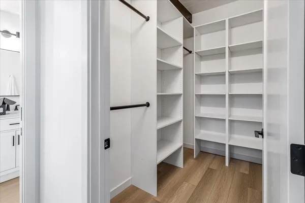 a bedroom with a bed mirror and window