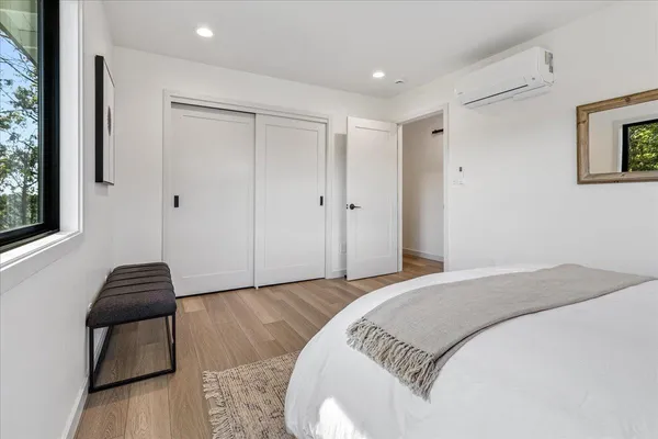 a bedroom with a bed and window