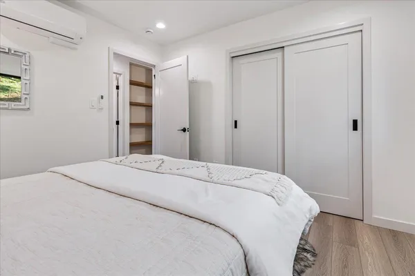 a bedroom with a bed and a window