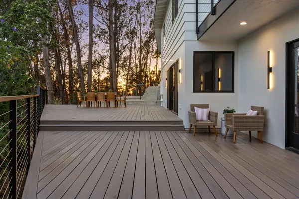 a view of house with roof deck and furniture