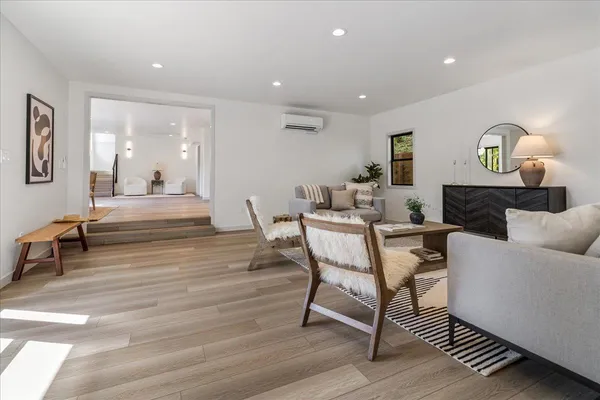 a living room with furniture and a wooden floor