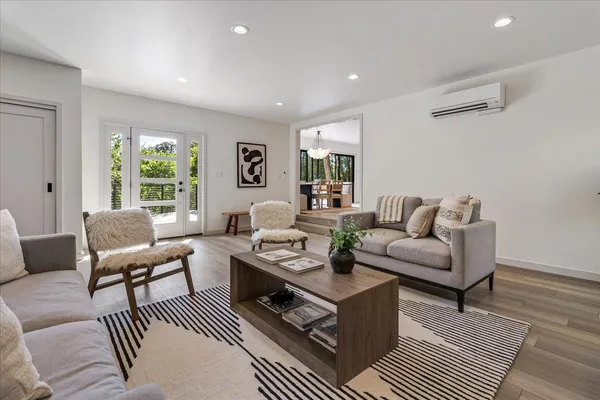 a living room with furniture wooden floor and window