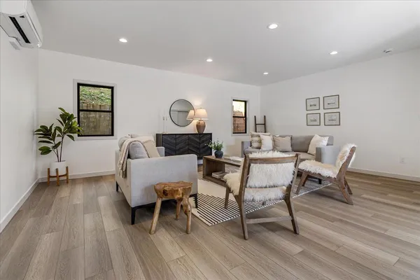 a living room with furniture a potted plant and a table