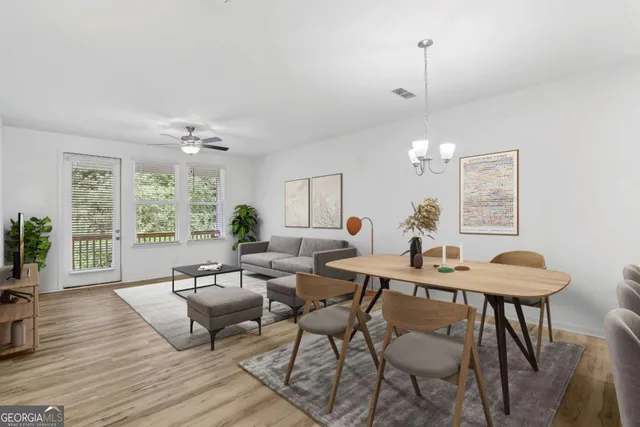 a view of a dining room with furniture window and wooden floor