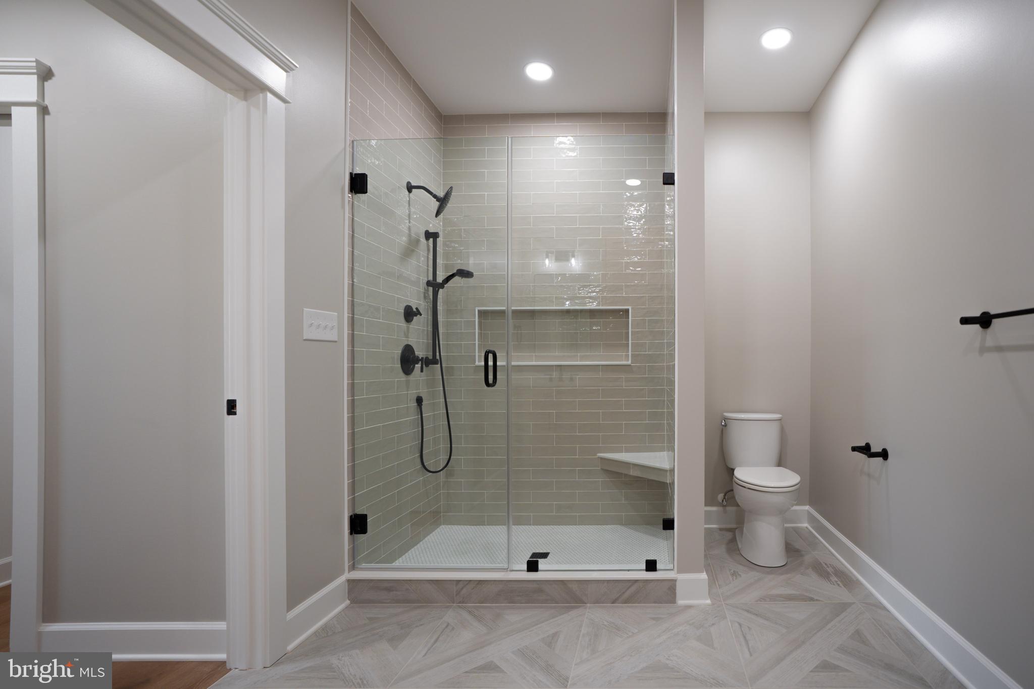 22430 Hummingbird Road Ellendale, DE 19941 - Photo 11 of 39 a bathroom with a shower a toilet and a shower