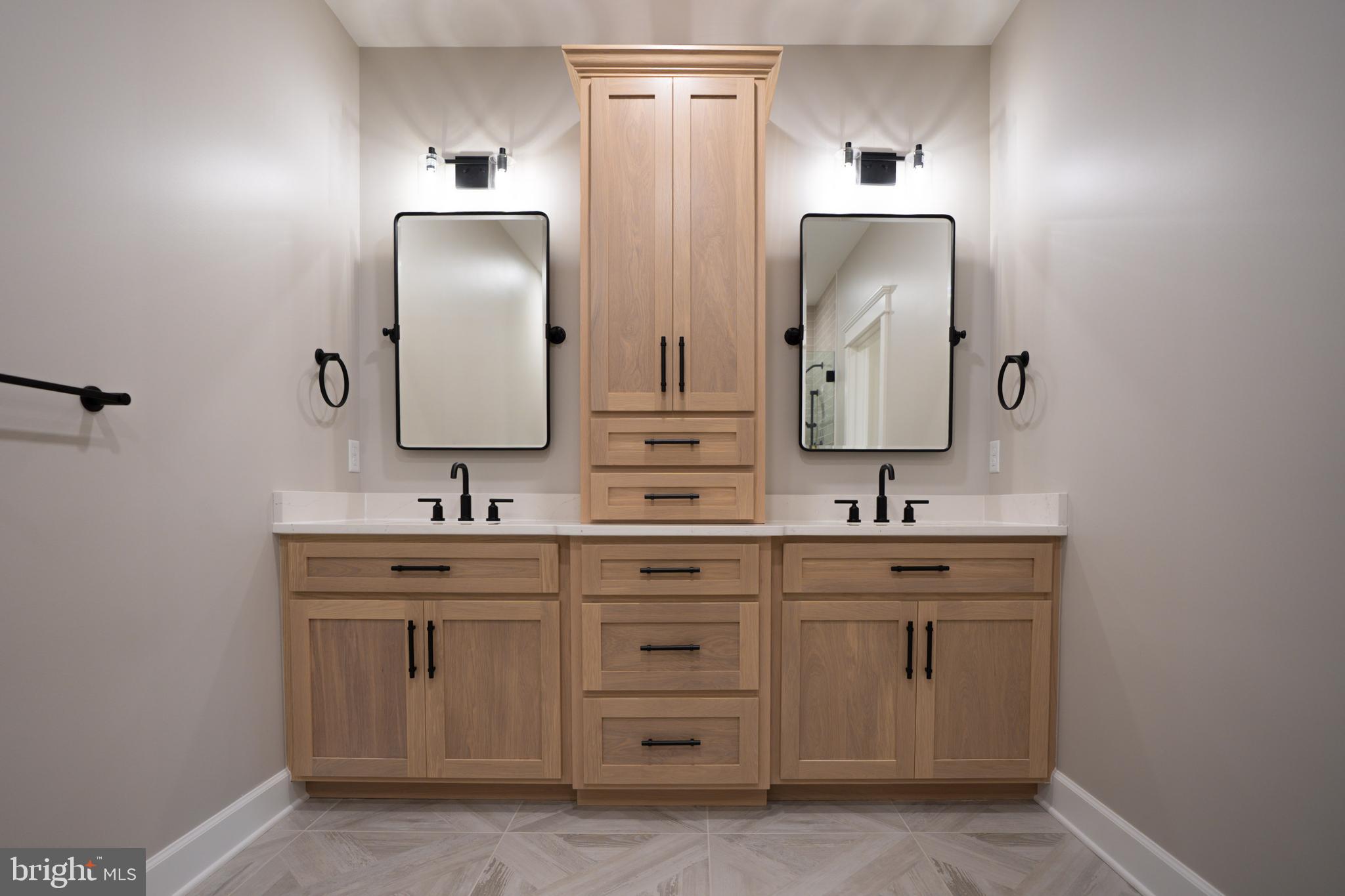 22430 Hummingbird Road Ellendale, DE 19941 - Photo 12 of 39 a bathroom with a double vanity sink and mirror