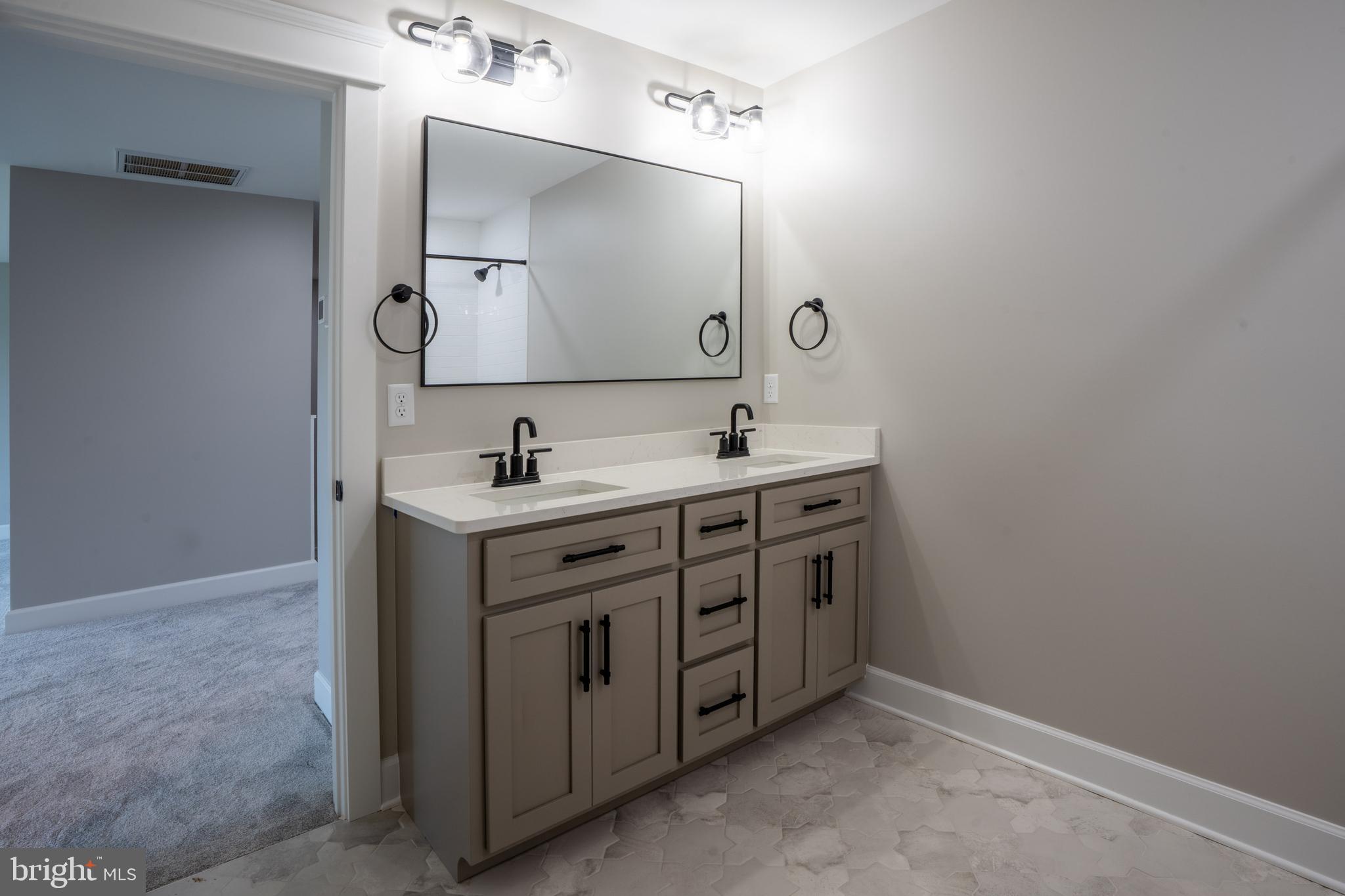 22430 Hummingbird Road Ellendale, DE 19941 - Photo 13 of 39 a bathroom with a sink and a mirror