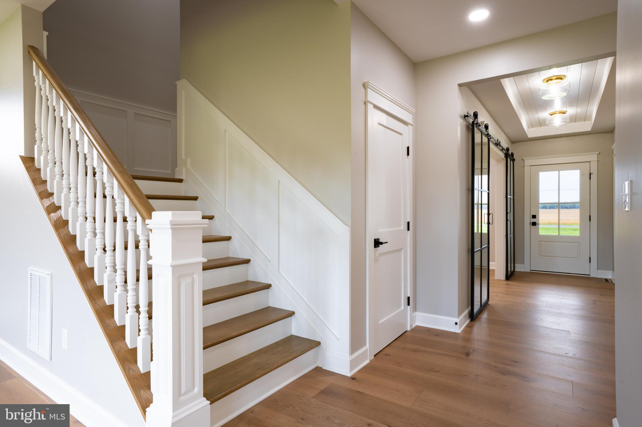 22430 Hummingbird Road Ellendale, DE 19941 - Photo 16 of 39 a view of a hallway with wooden floor and entryway