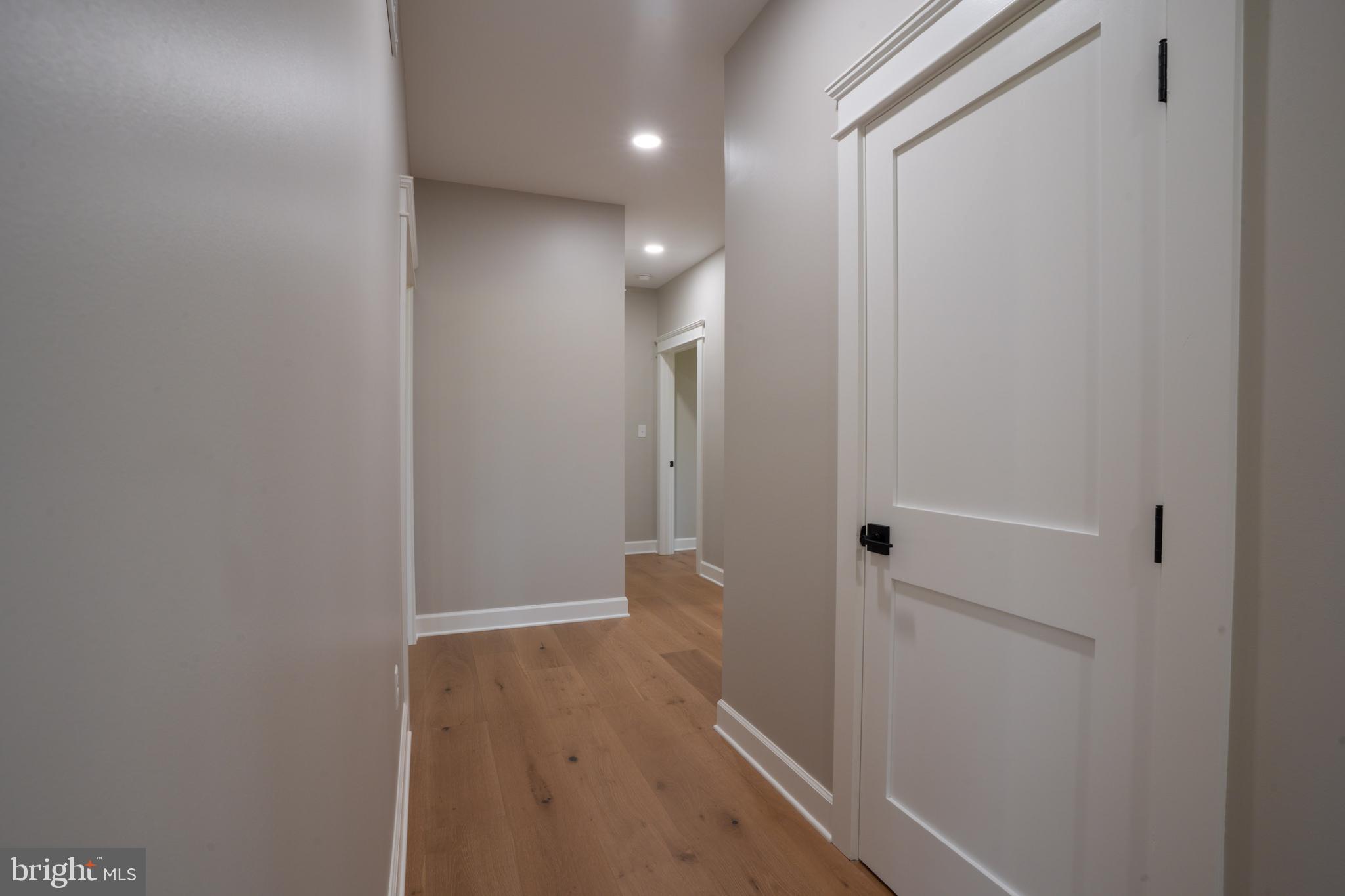 22430 Hummingbird Road Ellendale, DE 19941 - Photo 23 of 39 a view of a hallway with wooden floor