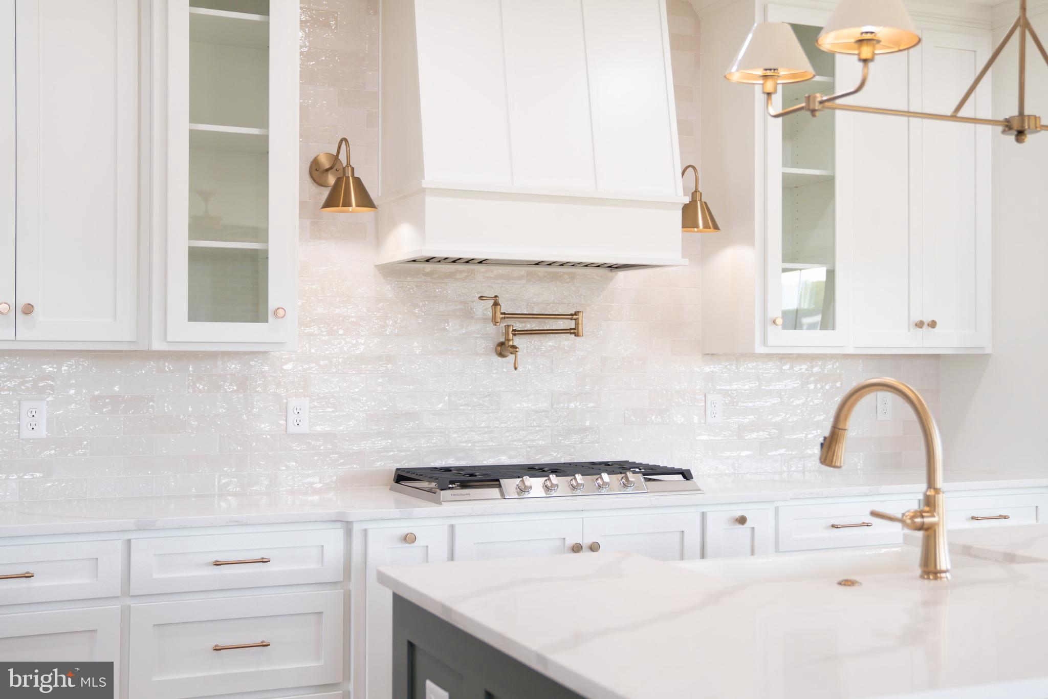 22430 Hummingbird Road Ellendale, DE 19941 - Photo 5 of 39 a kitchen with cabinets and a stove top oven