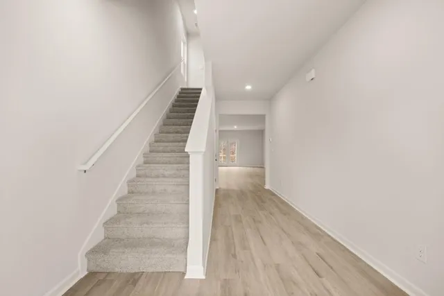 a view of entryway and hall with wooden floor