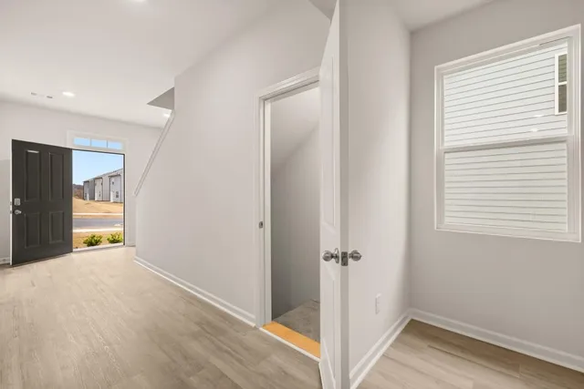 a view of hallway with wooden floor