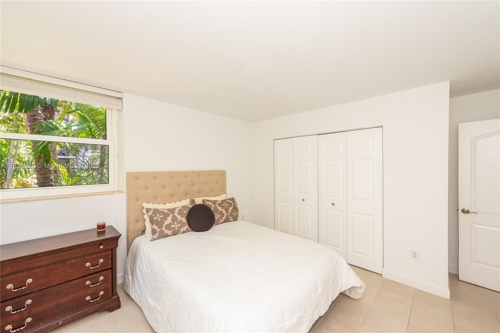 101 Ocean Ln Drive, Unit 2017 Key Biscayne, FL 33149 - Photo 19 of 25 a bedroom with a bed and a window