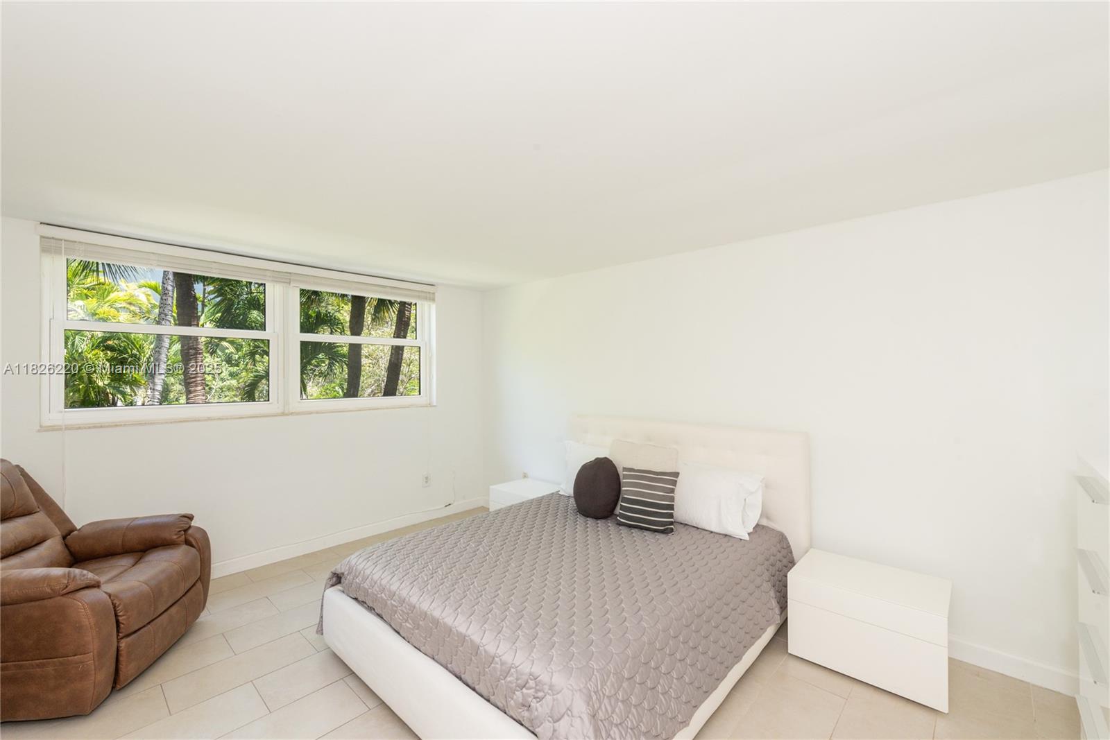 101 Ocean Ln Drive, Unit 2017 Key Biscayne, FL 33149 - Photo 7 of 25 a bedroom with a bed and a couch