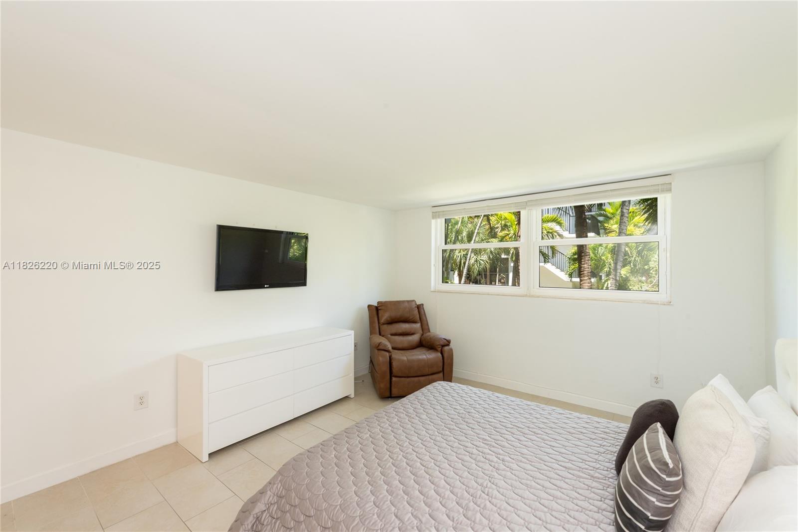 101 Ocean Ln Drive, Unit 2017 Key Biscayne, FL 33149 - Photo 8 of 25 a bedroom with a bed and a window