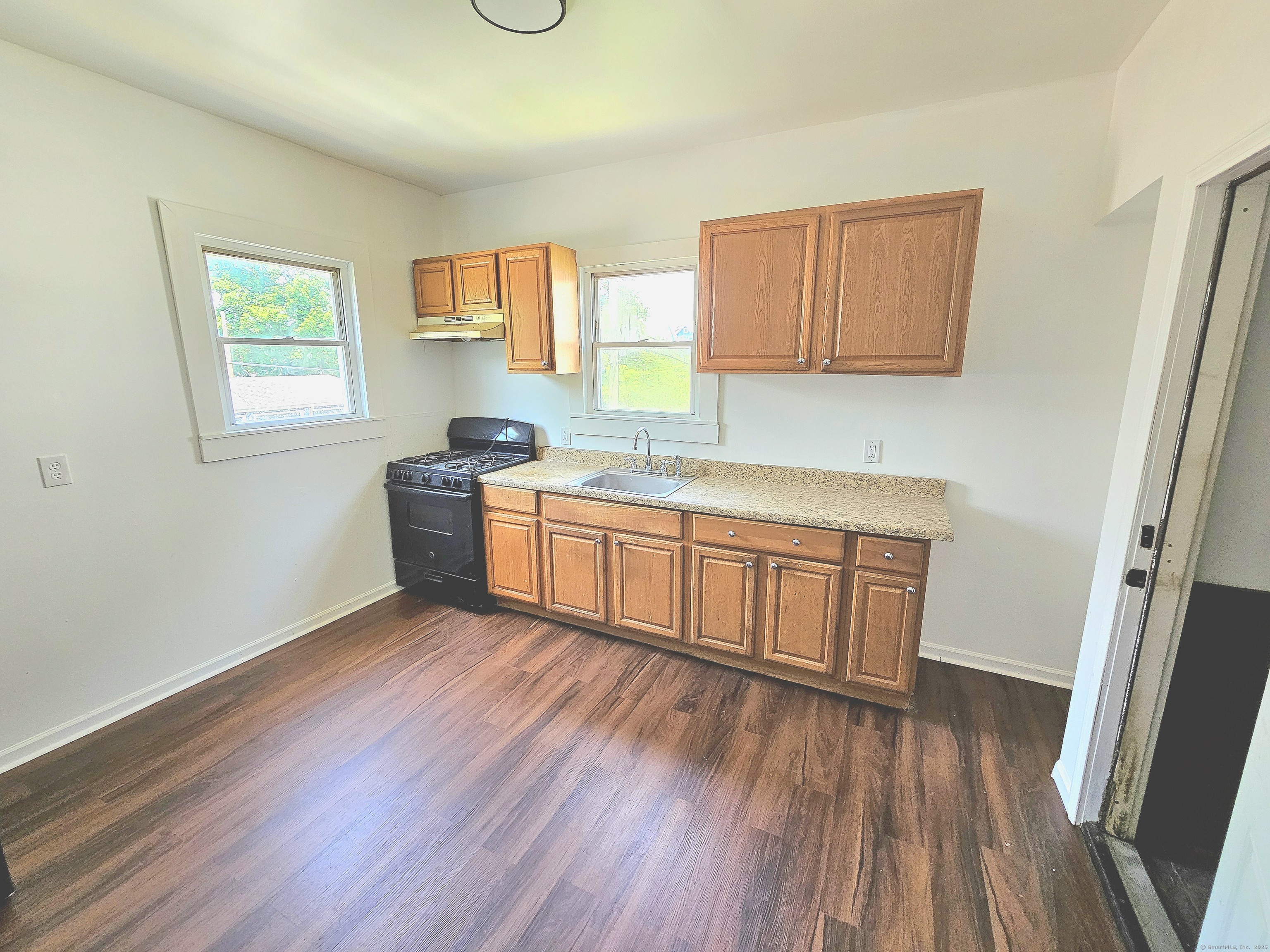 483 Ferry Street, Unit 2 New Haven, CT 06513 - Photo 3 of 11 a kitchen with stainless steel appliances wooden floors and wooden cabinets