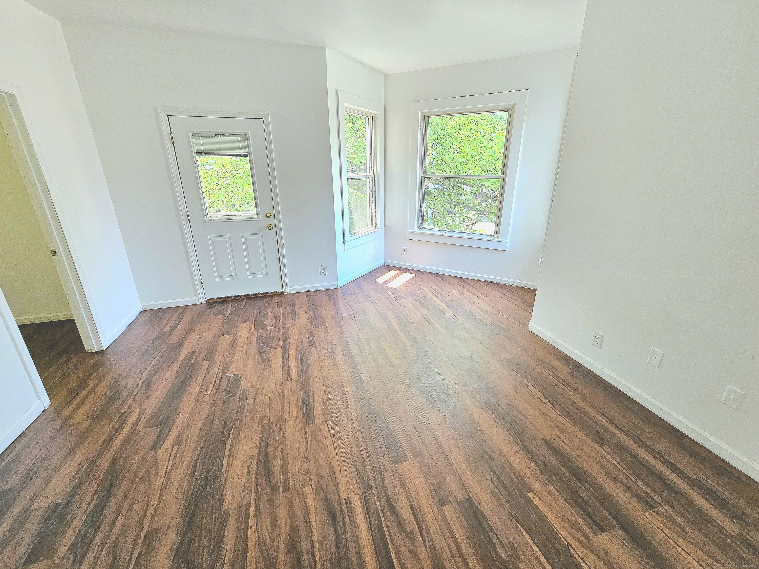 483 Ferry Street, Unit 2 New Haven, CT 06513 - Photo 6 of 11 an empty room with wooden floor and windows