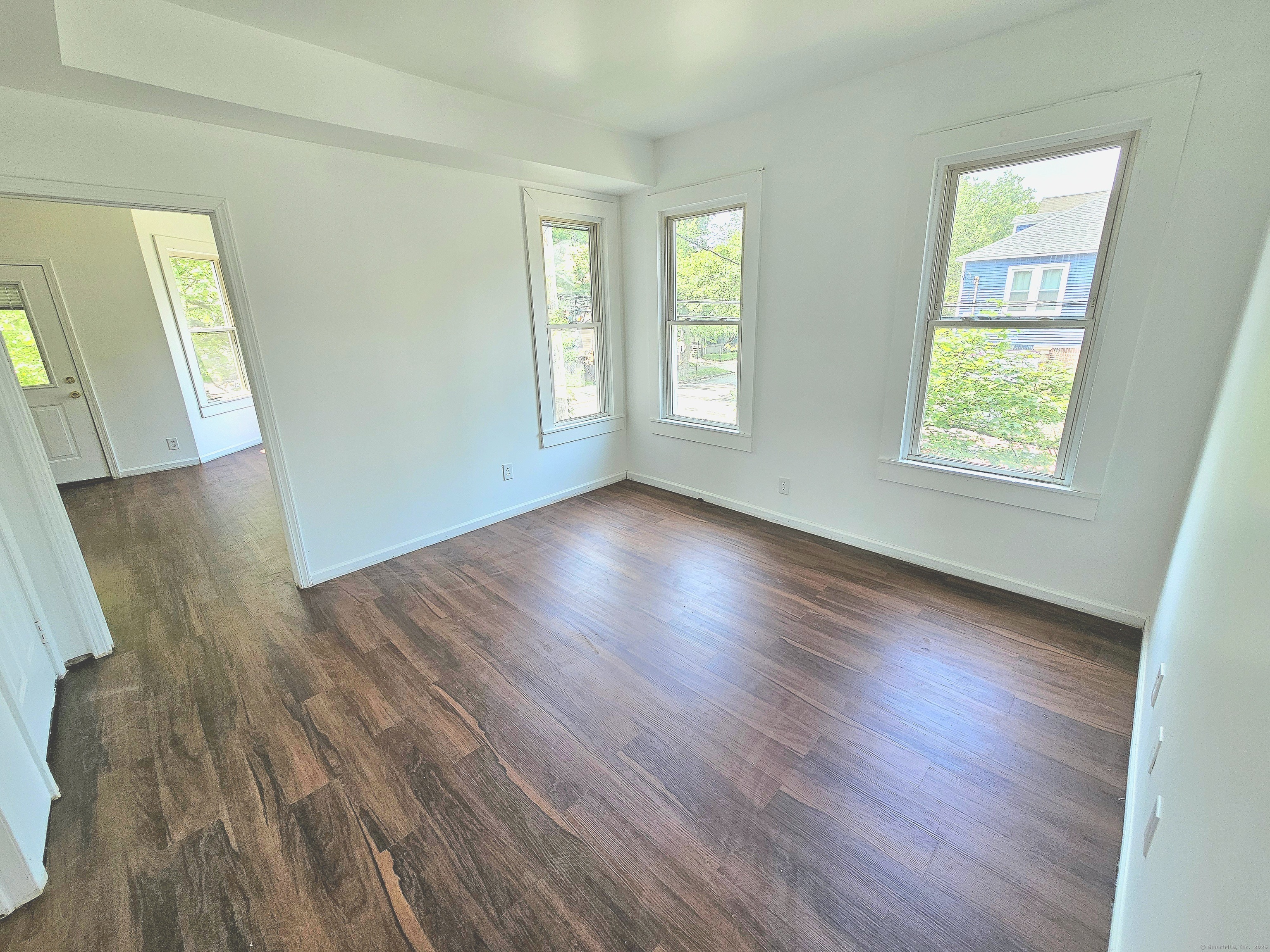 483 Ferry Street, Unit 2 New Haven, CT 06513 - Photo 7 of 11 a view of an empty room with wooden floor and a window