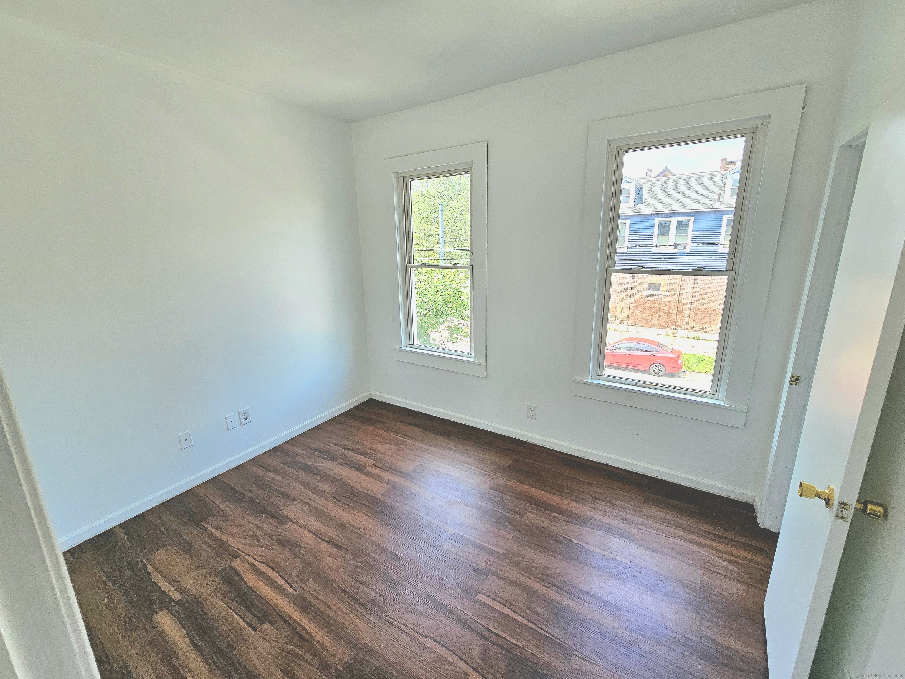 483 Ferry Street, Unit 2 New Haven, CT 06513 - Photo 8 of 11 a view of an empty room with wooden floor and a window