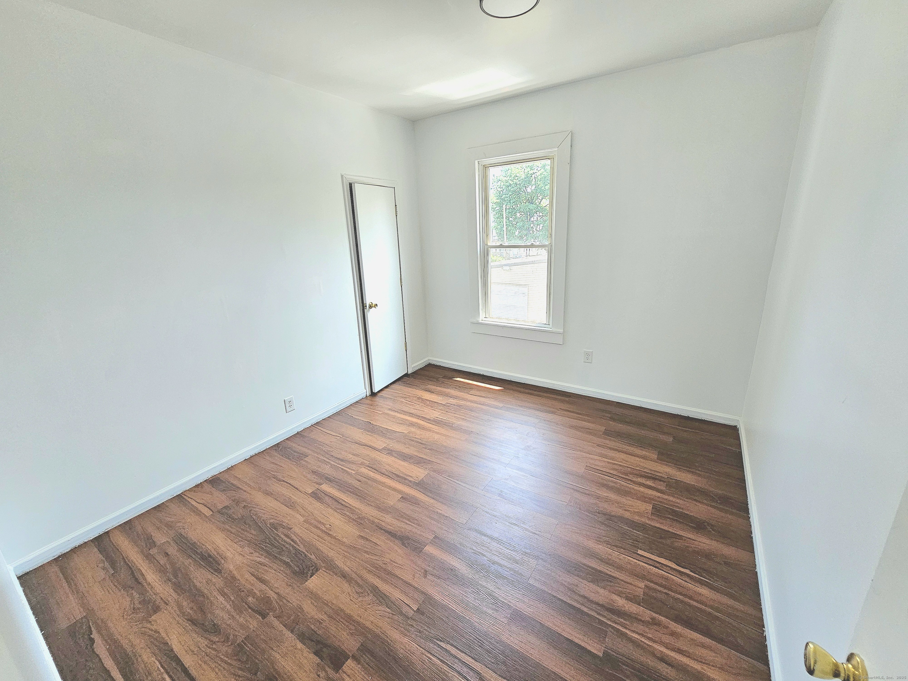 483 Ferry Street, Unit 2 New Haven, CT 06513 - Photo 10 of 11 an empty room with wooden floor and windows