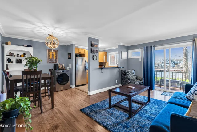 a living room with furniture a rug and a large window