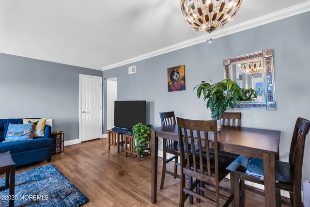 a dining room with furniture and wooden floor