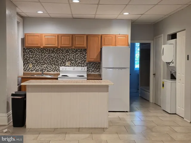 a kitchen with a refrigerator and a sink