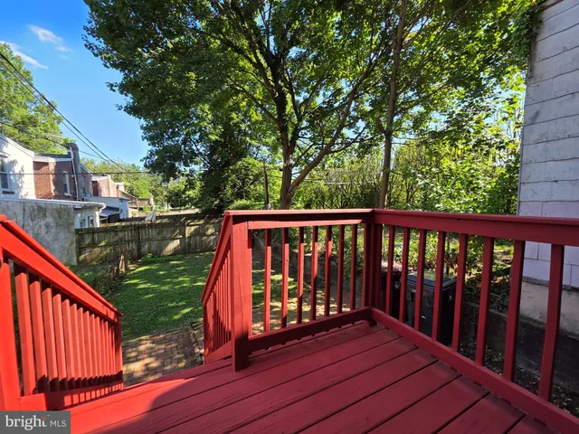 a view of balcony with wooden floor and fence