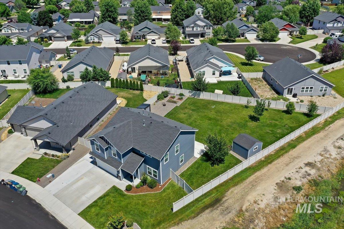 12310 West Hidden Point Drive Star, ID 83669 - Photo 43 of 48 Expansive property featuring a two-story residence with a dark gray shingle roof and light blue siding