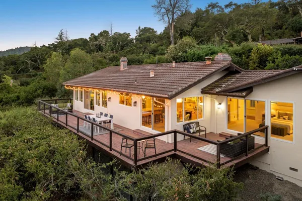 an aerial view of a house with swimming pool and big yard