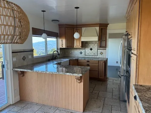 a kitchen with a sink a counter top space and cabinets