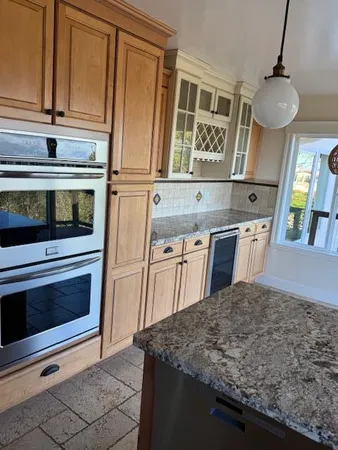 a kitchen with stainless steel appliances granite countertop a stove microwave and cabinets