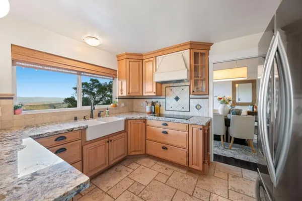a kitchen with stainless steel appliances granite countertop a sink and cabinets