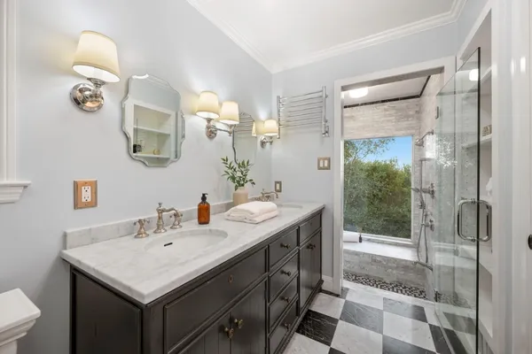 a bathroom with a toilet a sink a mirror and vanity