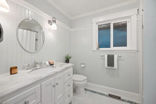 a bathroom with a double vanity sink mirror and toilet
