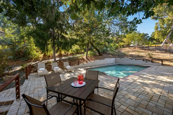 a view of a backyard with swimming pool
