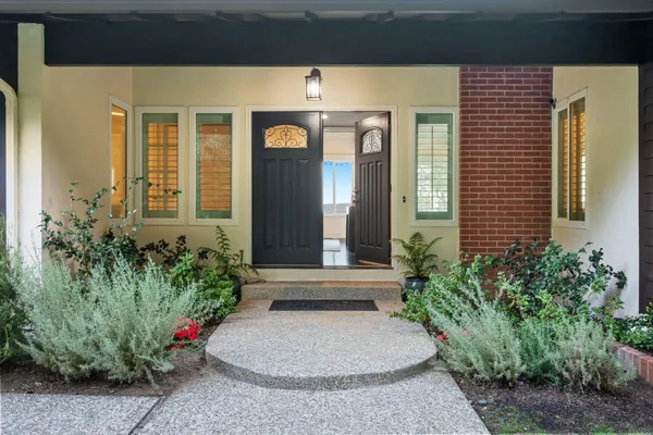 a front view of a house with a garden