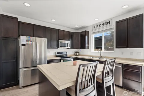 a kitchen with a sink stove and microwave