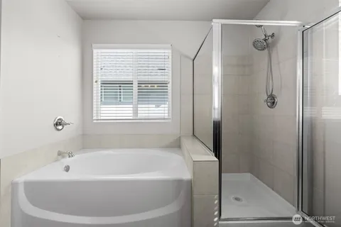 a bathroom with a bathtub and shower